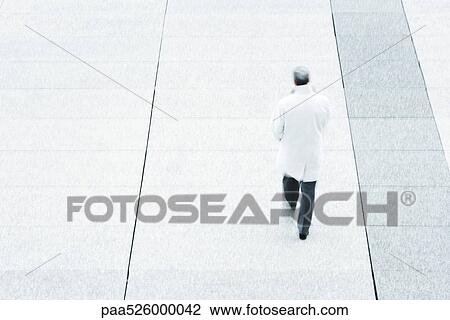 High angle rear view of business man walking down sidewalk View Large Photo Image Stock Image - High angle rear view of business man walking down sidewalk. Fotosearch