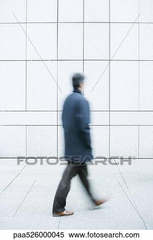 Man walking with hands in pockets down sidewalk View Large Photo Image Stock Photography - Man walking with hands in pockets down sidewalk. Fotosearch