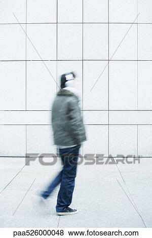 Man walking with hands in pockets on sidewalk View Large Photo Image Stock Photo - Man walking with hands in pockets on sidewalk. Fotosearch