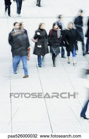 Pedestrians walking across public square View Large Photo Image Stock Image - Pedestrians walking across public square. Fotosearch