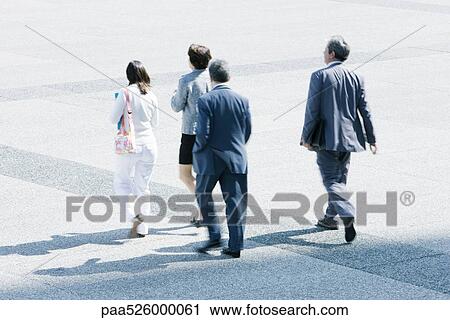 Pedestrians walking across public square View Large Photo Image Stock Image - Pedestrians walking across public square. Fotosearch