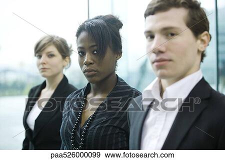 Three business associates standing side by side looking at camera View Large Photo Image Stock Photo - Three business associates standing side by side looking at camera. Fotosearch