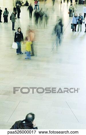 Tourists and commuters mingle in Grand Central Station in New York City View Large Photo Image Stock Photo - Tourists and commuters mingle in Grand Central Station in New York City. Fotosearch