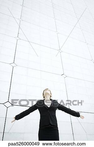 Woman standing with arms outstretched head back looking up View Large Photo Image Stock Photo - Woman standing with arms outstretched head back looking up . Fotosearch