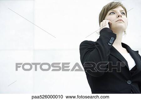 Young businesswoman talking on cell phone View Large Photo Image Stock Image - Young businesswoman talking on cell phone. Fotosearch