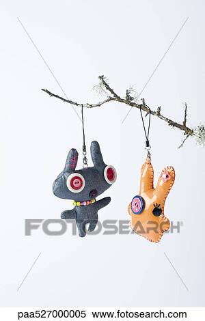 Stock Photography - Dolls hanging from branch. Fotosearch