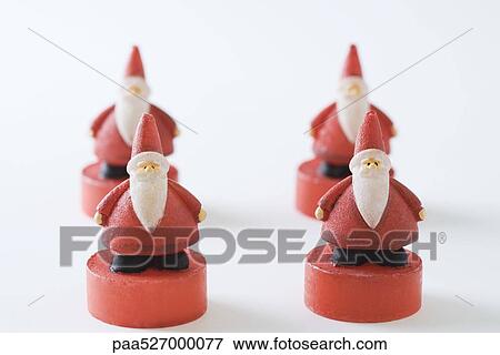Four Santa Claus figurines View Large Photo Image Stock Photo - Four Santa Claus figurines. Fotosearch