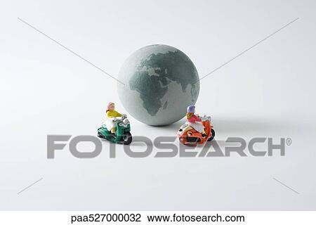 Miniature mopeds riding around globe View Large Photo Image Stock Image - Miniature mopeds riding around globe. Fotosearch