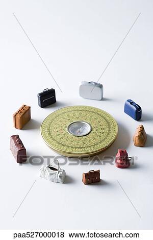 Miniature suitcases and bags arranged around Feng Shui compass View Large Photo Image Stock Photo - Miniature suitcases and bags arranged around Feng Shui compass. Fotosearch
