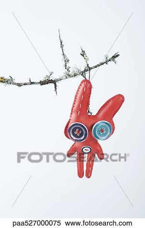 Stock Photography - Rabbit ornament hanging from branch. Fotosearch