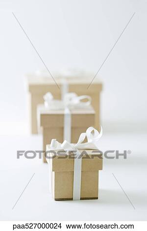 Three gifts lined up in increasing size View Large Photo Image Picture - Three gifts lined up in increasing size. Fotosearch