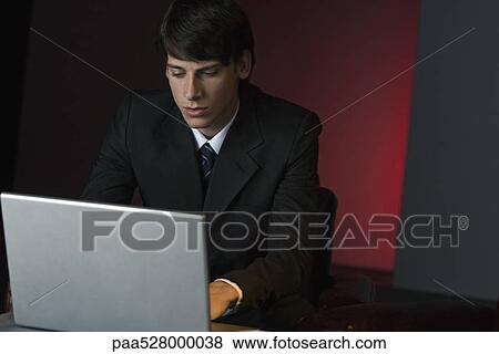 Businessman using laptop View Large Photo Image Stock Photo - Businessman using laptop. Fotosearch