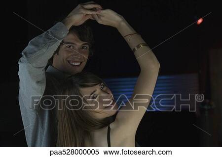 Couple dancing, smiling at camera, portrait View Large Photo Image Stock Photography - Couple dancing, smiling at camera, portrait. Fotosearch