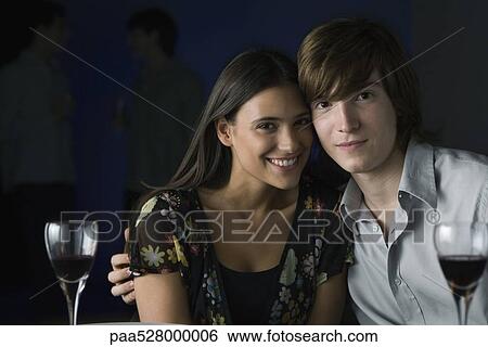 Couple sitting cheek to cheek, smiling at camera, portrait View Large Photo Image Stock Photograph - Couple sitting cheek to cheek, smiling at camera, portrait. Fotosearch