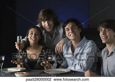 Friends having drinks at restaurant, smiling at camera, portrait View Large Photo Image Stock Image - Friends having drinks at restaurant, smiling at camera, portrait. Fotosearch