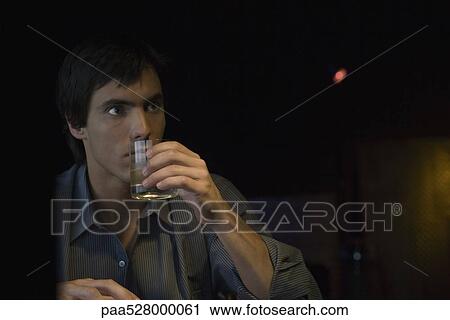 Man sipping whiskey, looking away View Large Photo Image Stock Image - Man sipping whiskey, looking away. Fotosearch