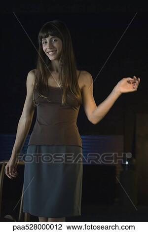 Woman smiling at camera, making gesture, portrait View Large Photo Image Stock Image - Woman smiling at camera, making gesture, portrait. Fotosearch