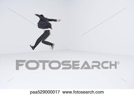Businessman leaping, blurred motion View Large Photo Image Stock Photo - Businessman leaping, blurred motion. Fotosearch