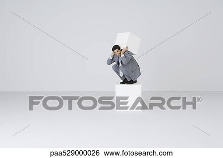 Businessman lifting block on back View Large Photo Image Stock Photograph - Businessman lifting block on back. Fotosearch