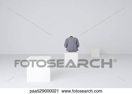 Businessman sitting on block with head down, rear view View Large Photo Image Stock Image - Businessman sitting on block with head down, rear view. Fotosearch