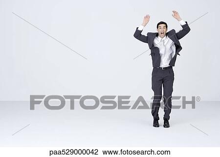 Businessman standing with arms up, mouth and eyes wide open View Large Photo Image Stock Image - Businessman standing with arms up, mouth and eyes wide open. Fotosearch