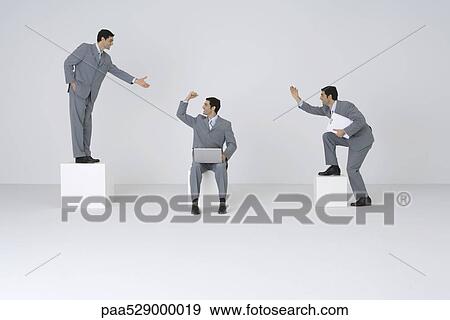 Stock Photo - Identical businessmen congratulating each other. Fotosearch