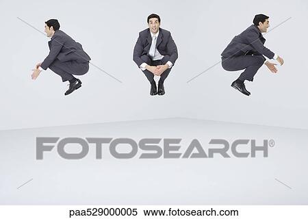 Stock Photography - Identical businessmen jumping in midair. Fotosearch