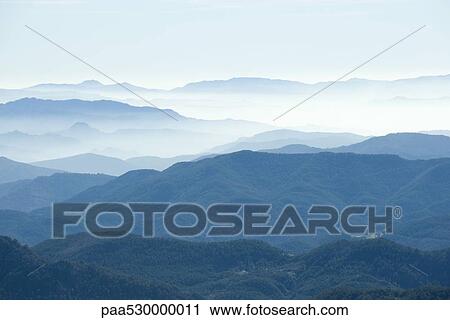 Stock Image - Foggy mountain landscape. Fotosearch