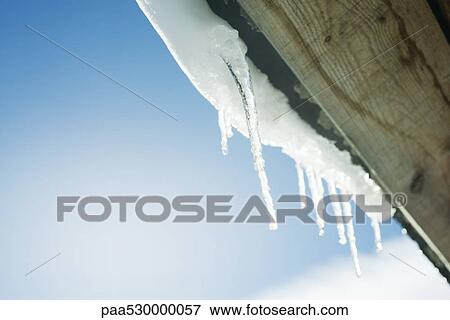 Icicles hanging from ledge, low angle view View Large Photo Image Stock Photo - Icicles hanging from ledge, low angle view. Fotosearch