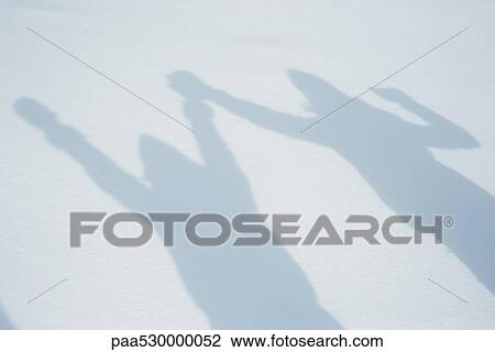 Shadow of people raising arms on snow View Large Photo Image Stock Image - Shadow of people raising arms on snow. Fotosearch