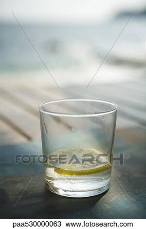Slices of lemon in a glass of water View Large Photo Image Stock Image - Slices of lemon in a glass of water. Fotosearch