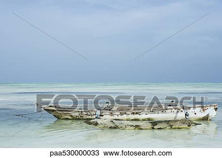 Wooden trimaran anchored in shallow water View Large Photo Image Stock Image - Wooden trimaran anchored in shallow water. Fotosearch