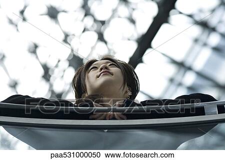 Female leaning against railing, low angle view View Large Photo Image Stock Image - Female leaning against railing, low angle view. Fotosearch
