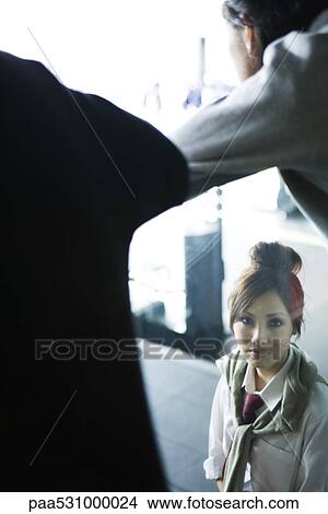 Picture - Woman looking through window at camera, high angle view. Fotosearch