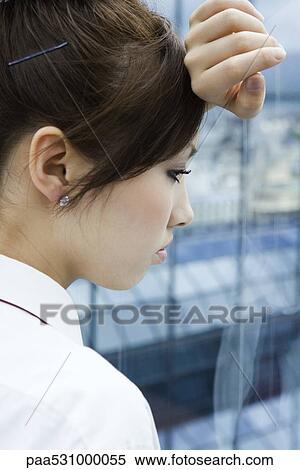 Young female resting head on arm against window, looking out, side view View Large Photo Image Stock Photography - Young female resting head on arm against window, looking out, side view. Fotosearch