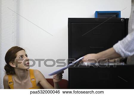 Stock Photograph - Colleagues filing documents . Fotosearch