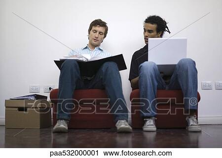Men working side by side, one with laptop, one with binder View Large Photo Image Stock Image - Men working side by side, one with laptop, one with binder. Fotosearch