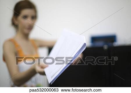 Woman holding out document, focus on foreground View Large Photo Image Stock Image - Woman holding out document, focus on foreground. Fotosearch