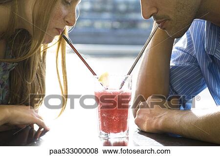 Couple sharing cool drink, cropped View Large Photo Image Stock Photo - Couple sharing cool drink, cropped. Fotosearch