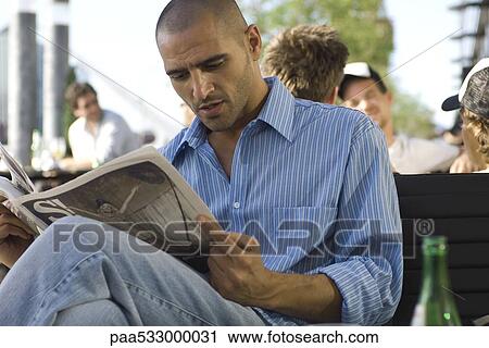 Man reading newspaper outdoors View Large Photo Image Stock Image - Man reading newspaper outdoors. Fotosearch