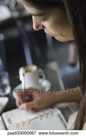 Woman writing in agenda, cropped View Large Photo Image Stock Photo - Woman writing in agenda, cropped. Fotosearch