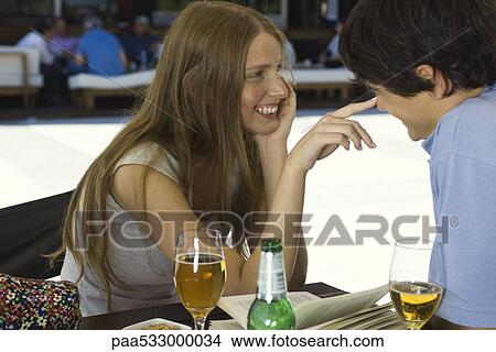 Young couple flirting in outdoor cafe View Large Photo Image Picture - Young couple flirting in outdoor cafe. Fotosearch