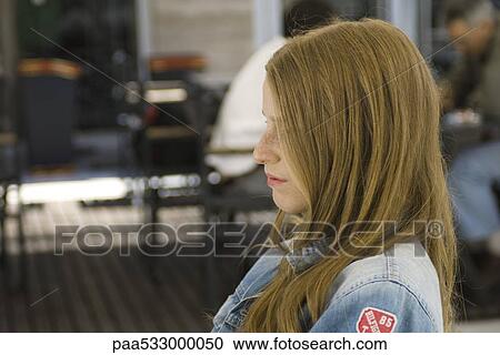Young woman sitting outdoors, profile View Large Photo Image Stock Image - Young woman sitting outdoors, profile. Fotosearch