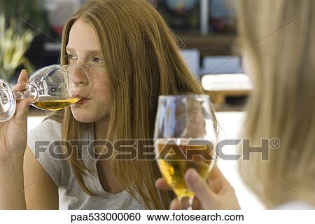 Young women drinking beer at an outdoor cafe View Large Photo Image Stock Image - Young women drinking beer at an outdoor cafe. Fotosearch