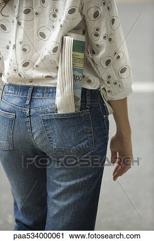 Woman with newspaper rolled up in back pocket of jeans, cropped view View Large Photo Image Stock Image - Woman with newspaper rolled up in back pocket of jeans, cropped view. Fotosearch