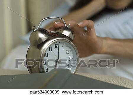 Woman's hand silencing alarm clock View Large Photo Image Stock Photo - Woman's hand silencing alarm clock. Fotosearch