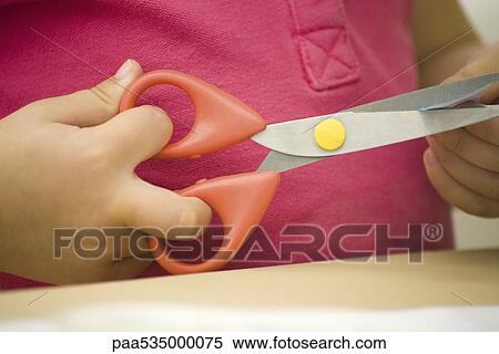 Stock Photography - Child using scissors, cropped view of hands. Fotosearch