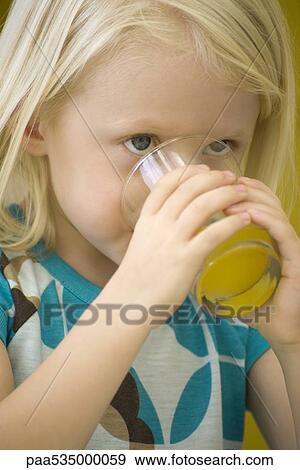 Little girl drinking glass of juice, close-up View Large Photo Image Stock Photo - Little girl drinking glass of juice, close-up. Fotosearch