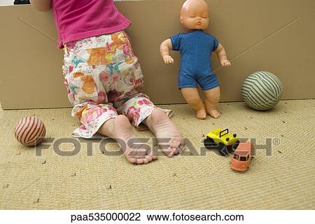 Little girl kneeling on floor with toys, rear view, cropped View Large Photo Image Stock Image - Little girl kneeling on floor with toys, rear view, cropped. Fotosearch