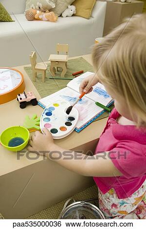 Little girl painting with watercolors View Large Photo Image Stock Photograph - Little girl painting with watercolors. Fotosearch
